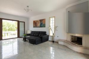 a living room with a couch and a fireplace at Sun Dream Villa in Ialysos