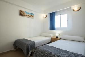 Vuode tai vuoteita majoituspaikassa Apartamentos Torre Yago