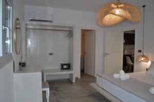 a bedroom with a bed and a table and a lamp at Erimo Vip in Vourvoúlos +23 photos