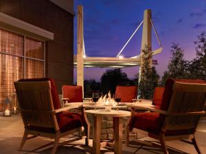 a dining table and chairs with a fire place at Louisville Marriott East in Louisville