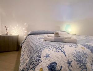 a bedroom with a bed with towels on it at Dimora Favale Guglielmi in Polignano a Mare +20 photos
