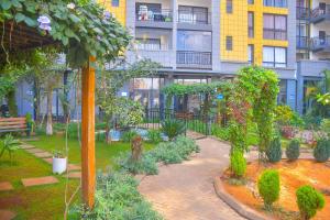 a garden in front of a building with plants at Chic 2-Bedroom Haven in Kilimani in Nairobi