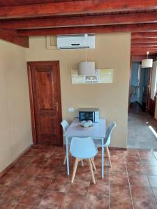 a table and chairs in a room with a door at Finca Esperanza in Yaiza