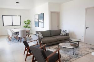 a living room with a couch and a table at Villa d'Anvers - Luxury Holiday Resort in Souda