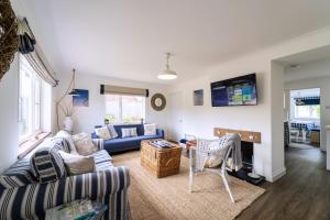 a living room with a couch and a table at Briar Lea in Aldeburgh