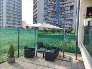 a patio with a table and chairs and an umbrella at FLH - Just 5 in Şelimbăr