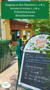 a sign in front of a building with a sign at Hofmanns B&B in Loosdorf