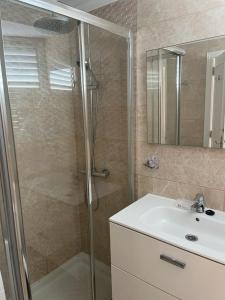 a bathroom with a shower and a sink at Cozy Apartment near the beach in Playa de las Americas