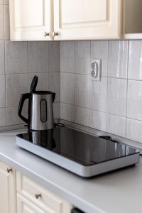 a coffee pot sitting on top of a stove in a kitchen at Barát Vendégház - Cosy Guesthouse - Teljes ház privát udvarral - 4 szoba, 2 fürdő in Szeged