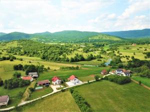 an aerial view of a home in a green field at Guest House Tonka in Otočac