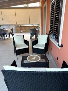 a patio with two chairs and a table and chairs at VistAmare - Fuscaldo in Marina di Fuscaldo