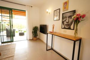 a living room with a vase of flowers on a table at Maspalomas Suite by "The Stay Las Palmas" VV in Maspalomas