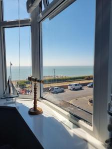 a window with a view of the ocean at 2 Bedroom Seafront Apartment in Felixstowe