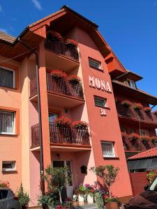 a building with flower boxes on the balconies at Willa Mona in Międzywodzie