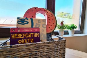 a basket filled with books and a plate of watermelon at South Beach Apartment in Varna City