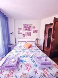 a bedroom with a bed with towels on it at South Beach Apartment in Varna City
