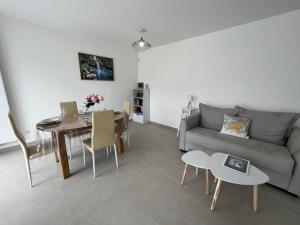 a living room with a couch and a table at View Point Lake and Mountains in Annecy