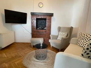 a living room with two chairs and a fireplace at Nona's view with balcony in Rijeka