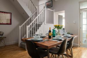 a dining room with a wooden table and chairs at Nythfa in Llanrwst