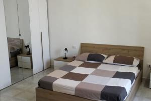 a bedroom with a large bed and two night stands at Alloggio privato "Ballatoio233" in Bisceglie