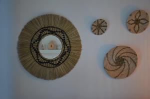 a mirror hanging on a wall with other items at Summer Residence in Provatas