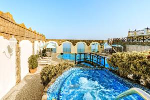 a swimming pool in the middle of a building at Hotel Terme Tritone Resort & Spa in Ischia