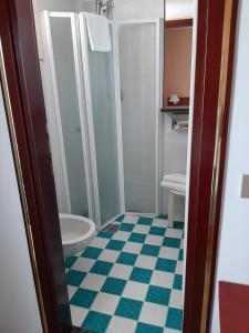 a bathroom with a shower and a toilet at Hotel Beny in Lido di Jesolo