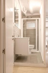 La salle de bains blanche est pourvue d'un lavabo et de toilettes. dans l'établissement Añisclo, à Barbastro