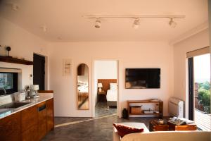 a living room with a kitchen and a bedroom at eftopia in Balodhimaíika
