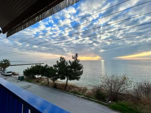 a view of the ocean from a balcony at Elena's Beach house in Nea Irakleia +2 photos