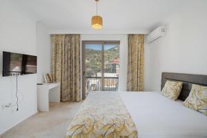 a bedroom with a bed and a large window at Bal Butik Otel in Datca