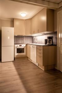 a kitchen with white appliances and a white refrigerator at Bergo Leiligheter in Beitostøl