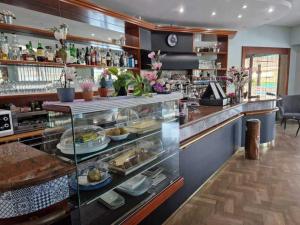 a restaurant with a counter with food on display at Hotel Dogana in San Marino