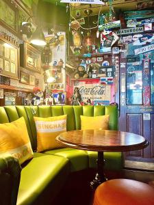 a restaurant with a table and a green couch and a table at Clifton Court Hotel in Blackpool