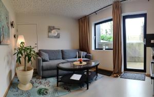 a living room with a couch and a table at Modern and comfortable apartment in attractive neighborhood in Stavanger