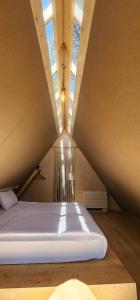 a room with a bed in a attic at LONGOSPHERE GLAMPING in Kırklareli