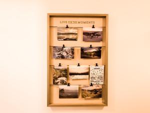 a display case with photographs on a wall at 4 Ben Avon in Aviemore