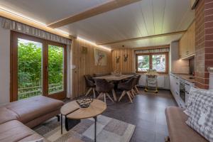 a living room with a couch and a table at Almhütten Sonnblick & Almfried in Sonnenalpe Nassfeld