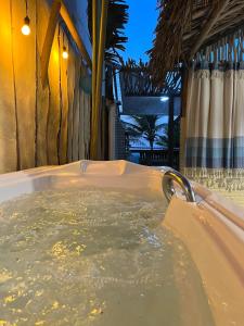 a jacuzzi tub in a resort at night at ASAS DEL MAR - SUITES in Canoa Quebrada
