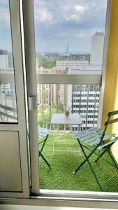 a view of a balcony with a table and chairs at Beautiful apartment with Eiffel tower view in Puteaux