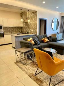 a living room with a couch and a kitchen at Tranquility in the Midst of Vibrance in Nairobi