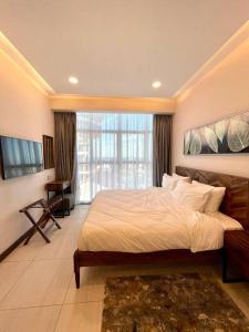 a bedroom with a large bed and a large window at Tranquility in the Midst of Vibrance in Nairobi