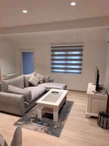 a living room with a couch and a coffee table at Guest House Martinovic in Bečići