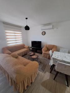 a living room with two couches and a table at Guest House Martinovic in Becici