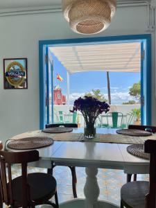 uma mesa de jantar com um vaso de flores em Hostal Bubango em San Andres y Sauces