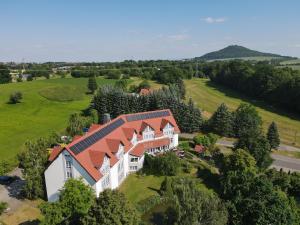 an overhead view of a large house with an orange roof at Hotel Marschall Duroc in Görlitz