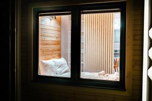 a window with a view of a bed in a room at Arche Siedlisko Piłka Boisko 