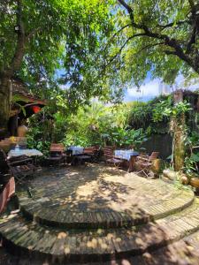 a patio with tables and chairs under a tree at Tầm Quên Homestay in Tây Ninh