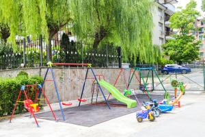 a playground with swings and a slide at Dadi Oazis Ravda in Ravda