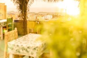 a table and chairs with a view of a city at The Rina Hostel in Agadir